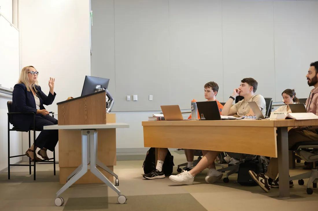 Law students in a classroom listening to a professor.